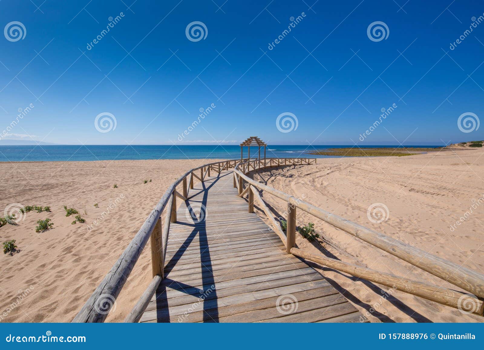 long curve wooden boardwalk footpath of beach in canos meca
