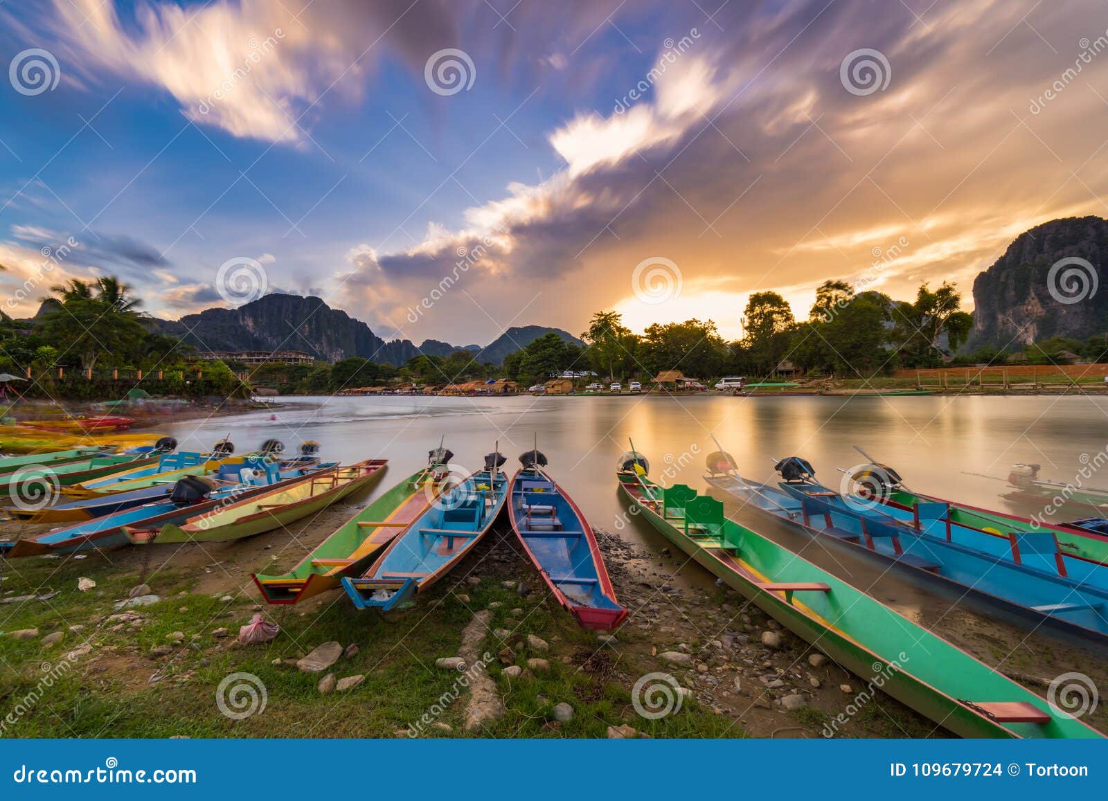 long exposure and long tail boats on naw song river in vang vieng, laos.