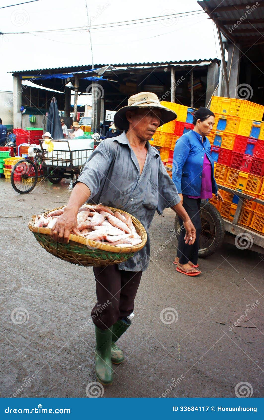 The Man Carry Fish Basket at Fishing Market. LONG Editorial