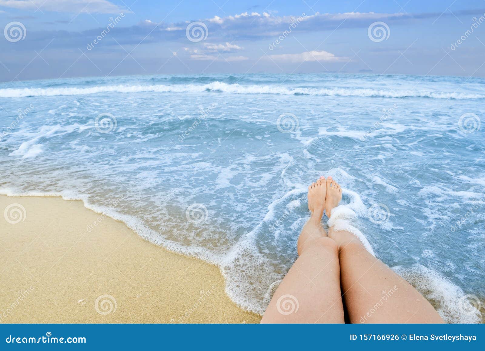 Long Tanned Girl Legs Against Background of Endless Blue Sea Water ...