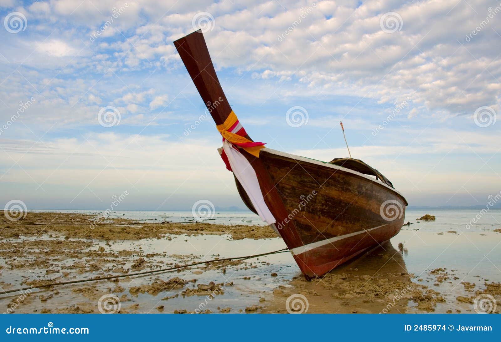 longtail boat in low tide