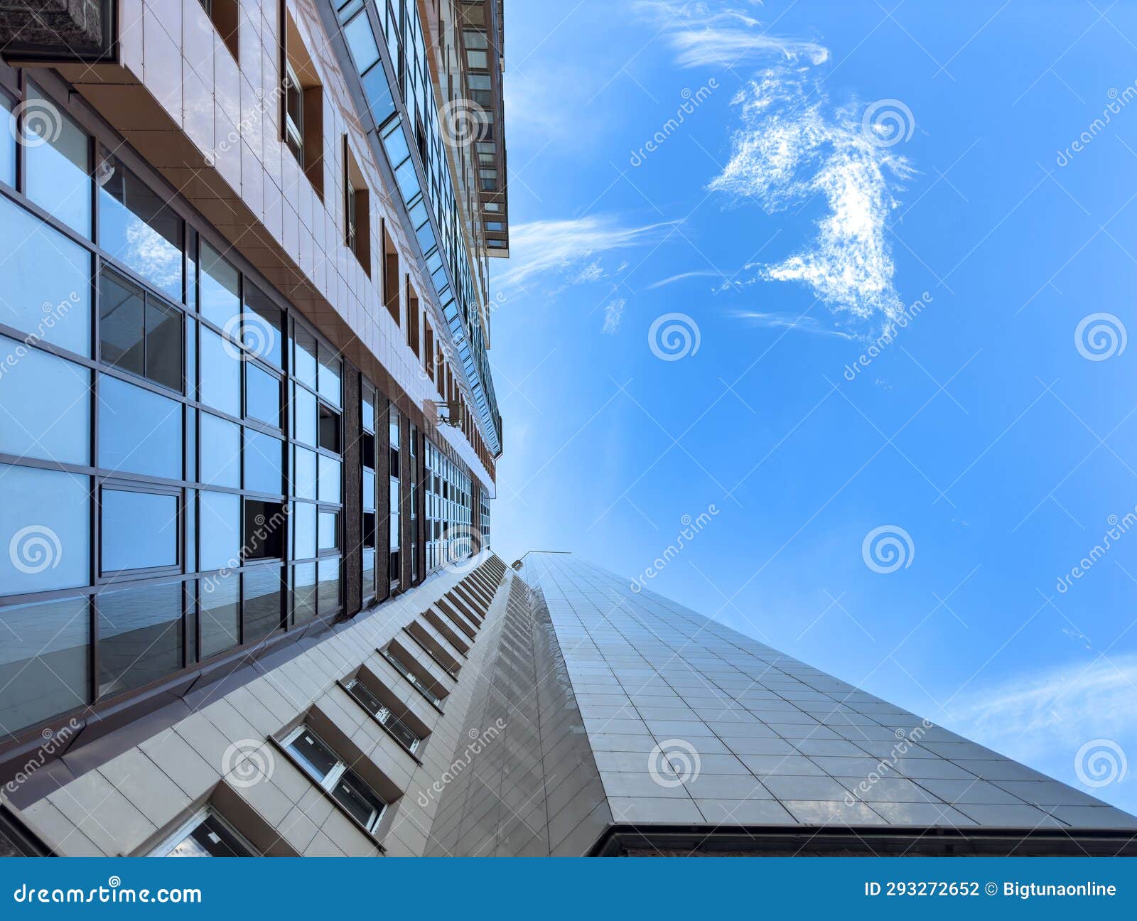 looking up downtown city skyscrappers with dramatic cloudy skies. modern building exterior