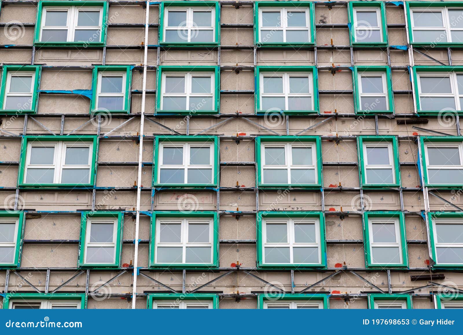 looking up at a tower block that has had its cladding removed due to being a fire hazard after the grenfell disaster, horatia