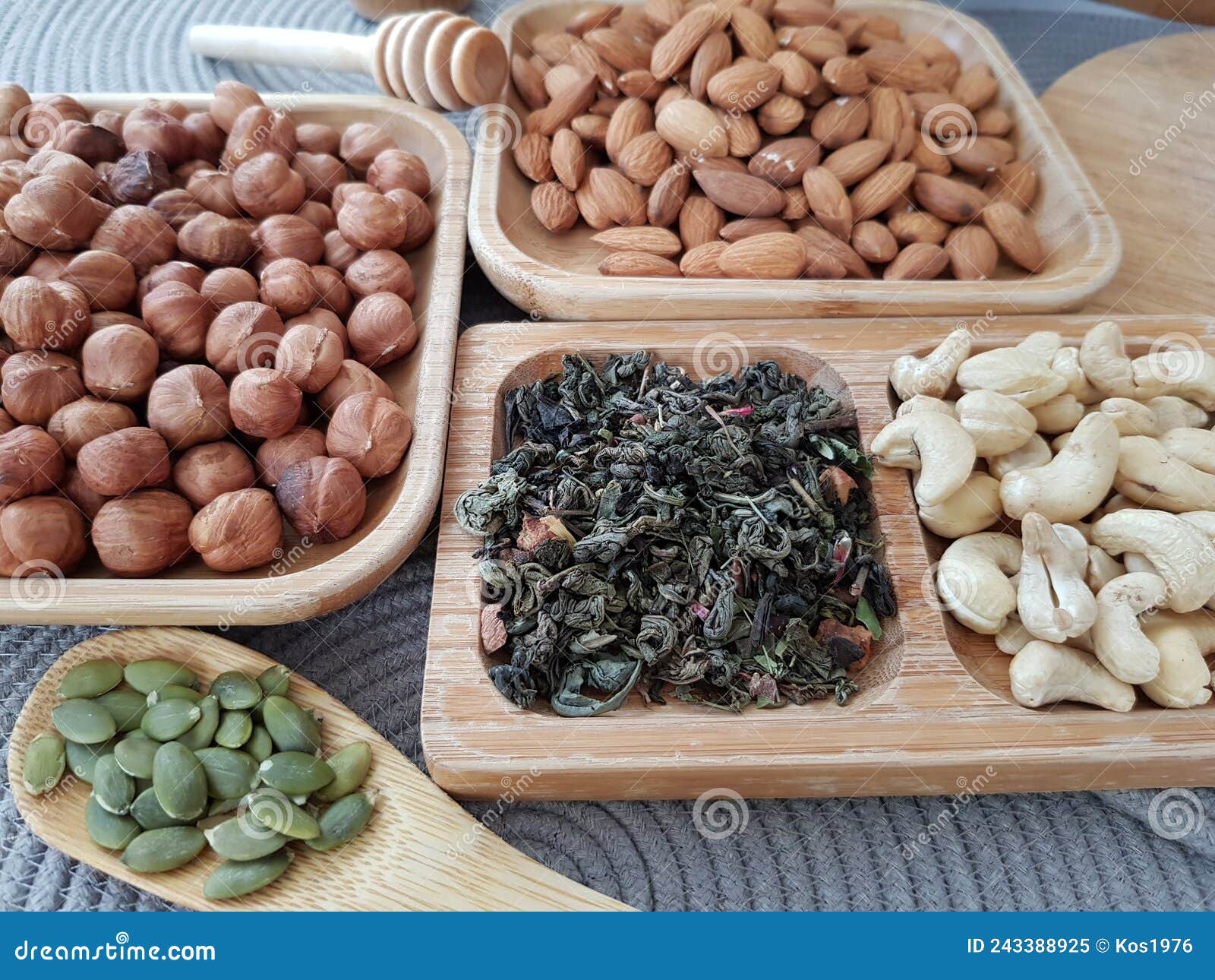 Leafy green tea and nuts stock image. Image of bowl 243388925