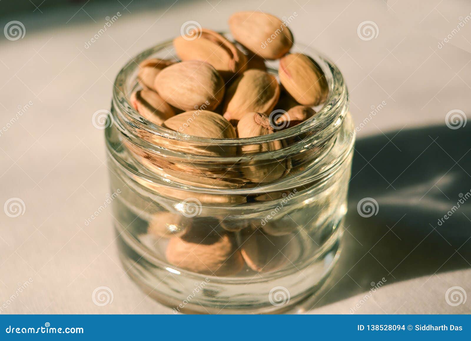 pistachio nuts in a glass container