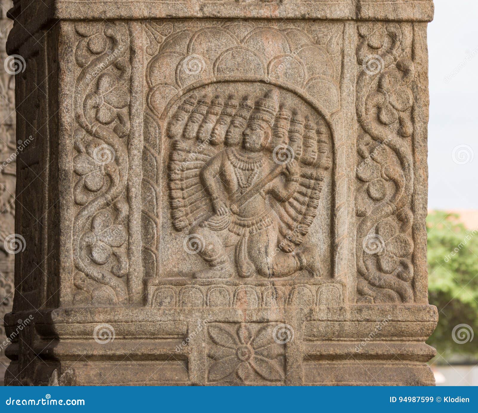 Lord Ravana mural at Srikanteshwara Temple in Ganjangud, India. Nanjangud, India - October 26, 2013: Closeup of chiseled mural of Lord Ravana with his ten heads in beige sandstone of the Mandapam at Srikanteshwara Temple.