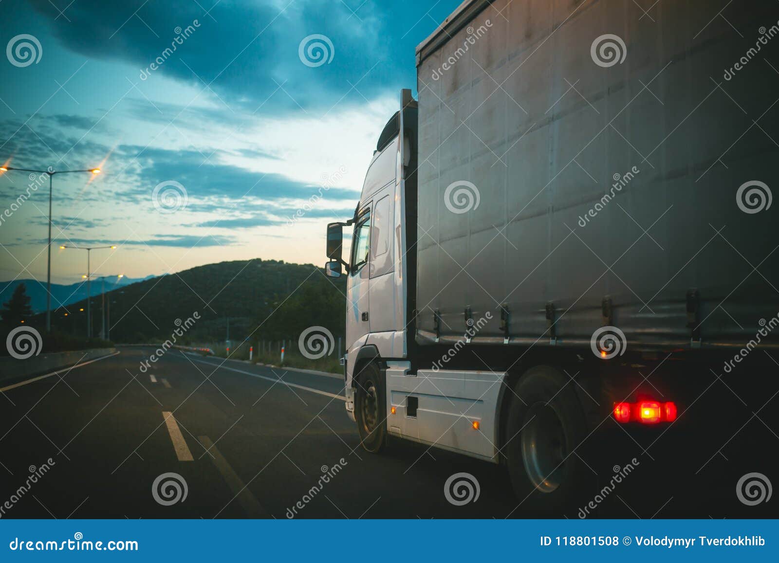 lorry car drive on road in evening. truck transport cargo. transportation and shipment. speed and delivery concept
