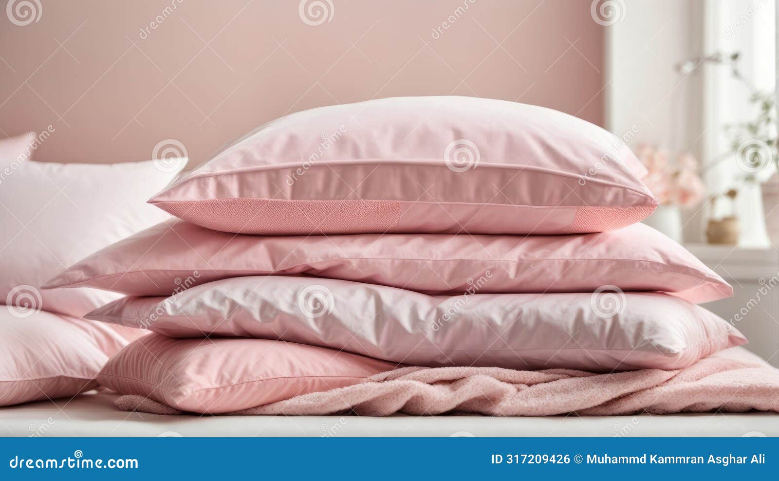 ?lose-up of a pile of bed linen pillows blankets pink pastel colors on white