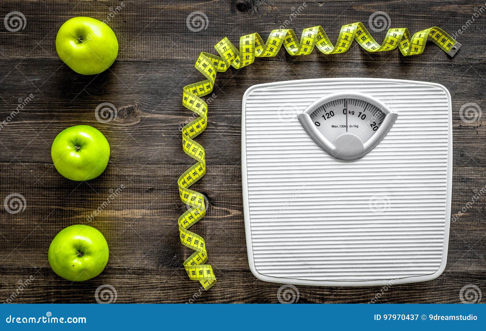 Lose weight concept. Bathroom scale, measuring tape, apples on wooden  background top view copyspace - Mile High Spine & Pain Center