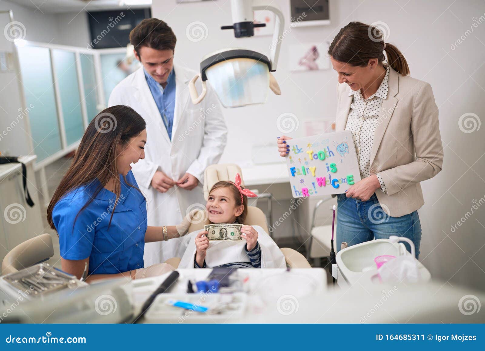 loss baby teeth. dentist examining his girl patient in dentistÃ¢â¬â¢s