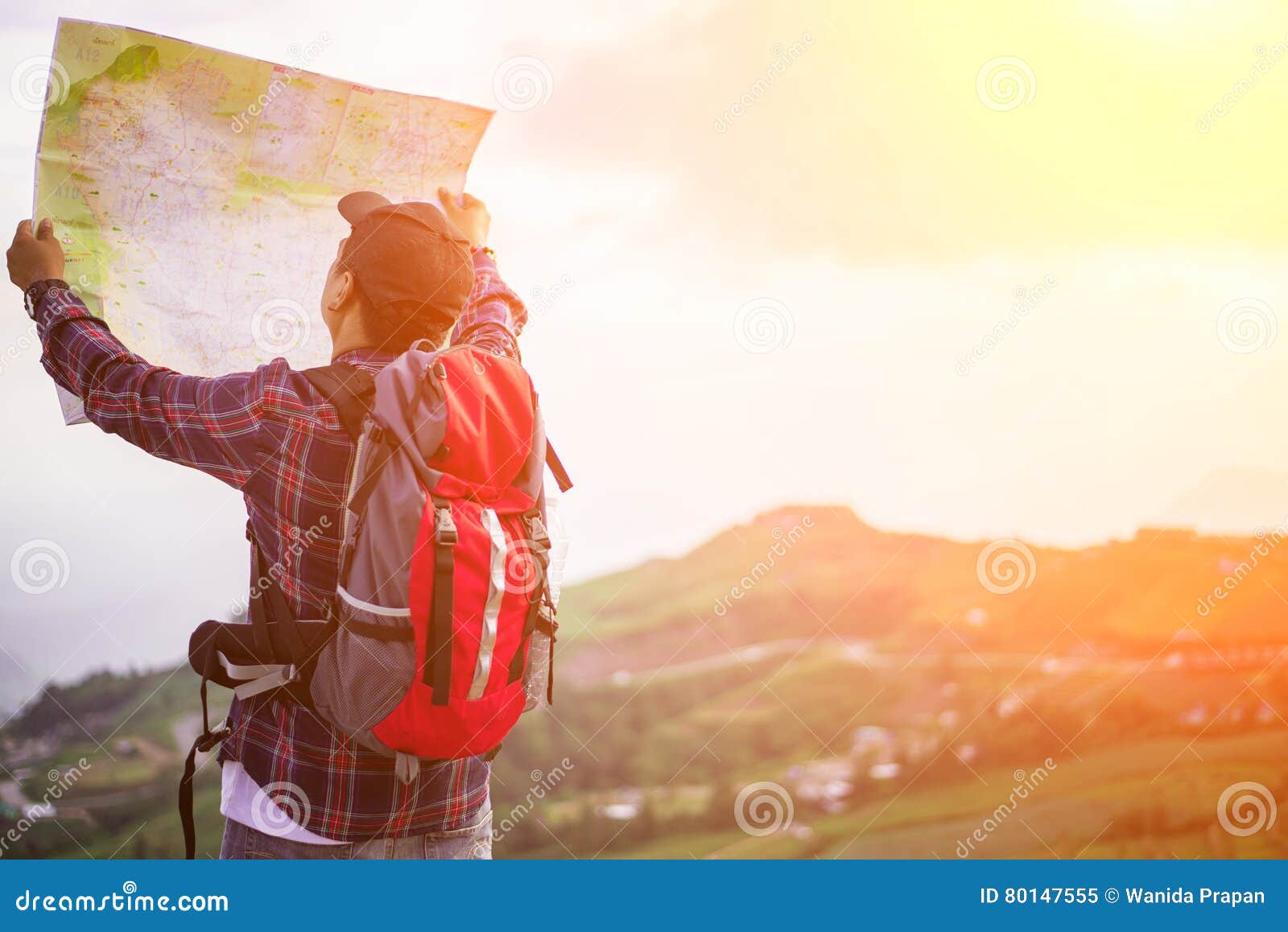 lost hiker with backpack checks map to find directions