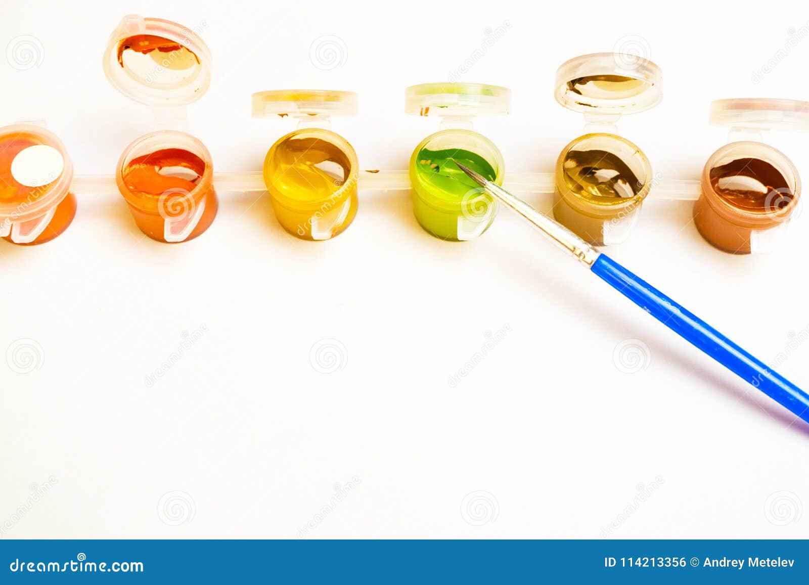 A Lot of Containers with Paint in a Row on Them is a Paintbrush, the