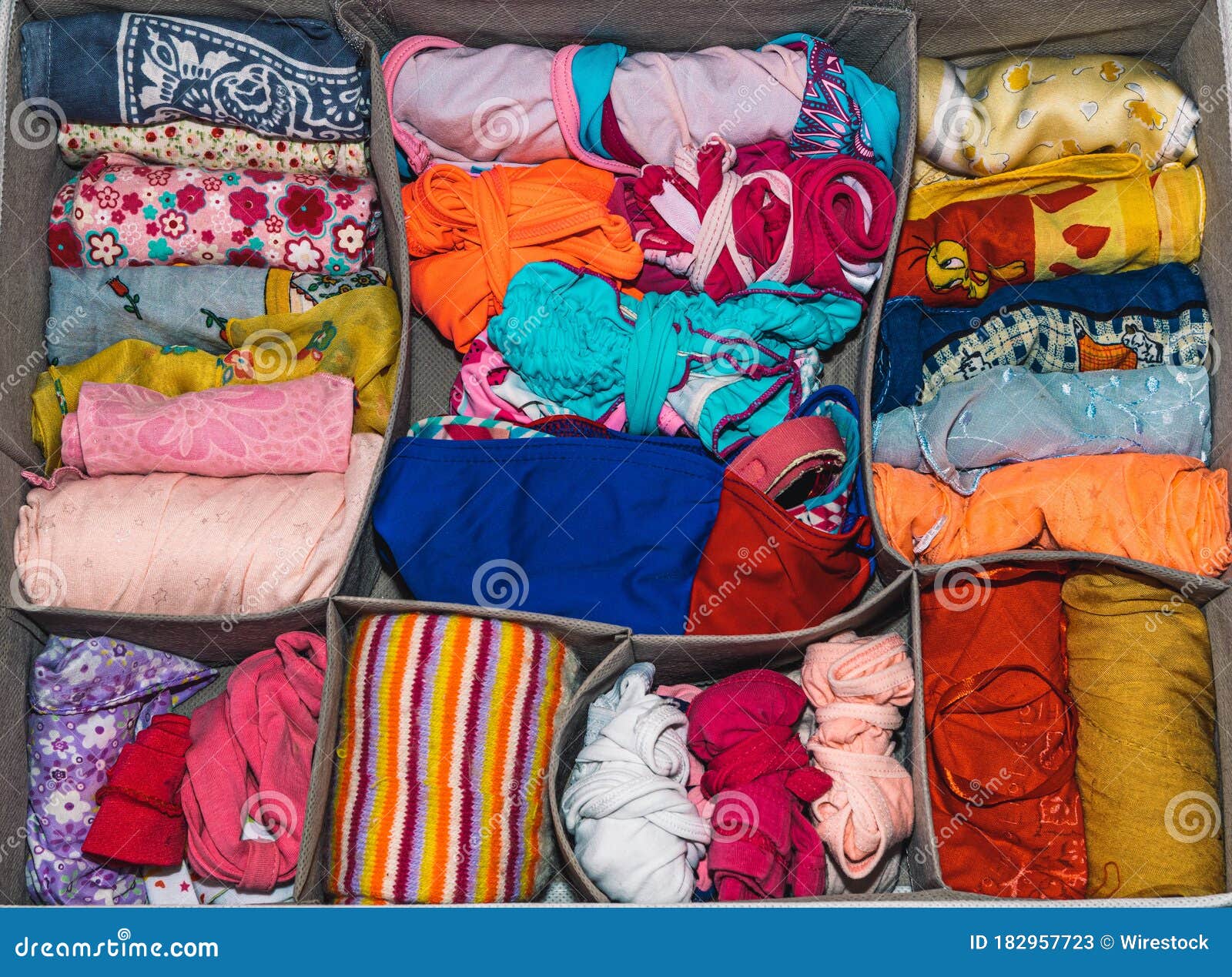 Lot of Different Types of Colorful Folded Pieces of Clothing in a Box