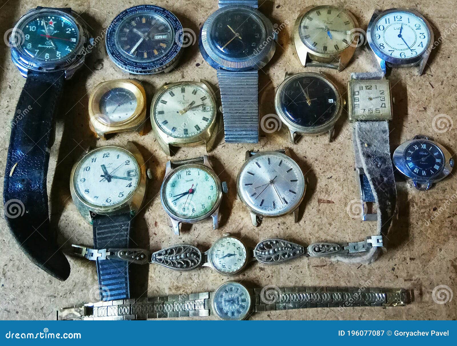 A Lot of Old Battered Broken Soviet Antique Watches Lie on the Wooden ...