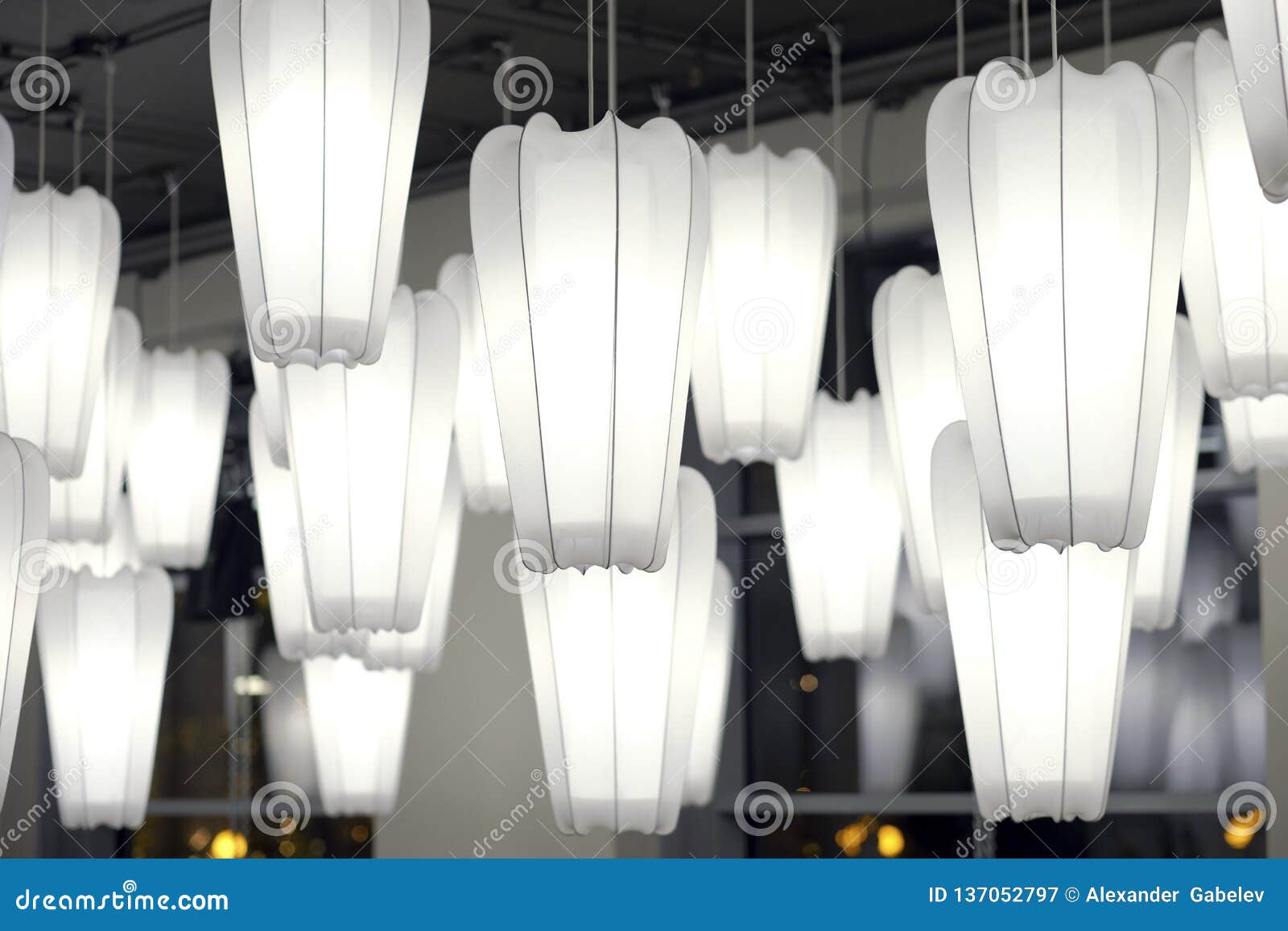 White Paper Lamp Hanging On The Ceiling In Dark Tone Stock