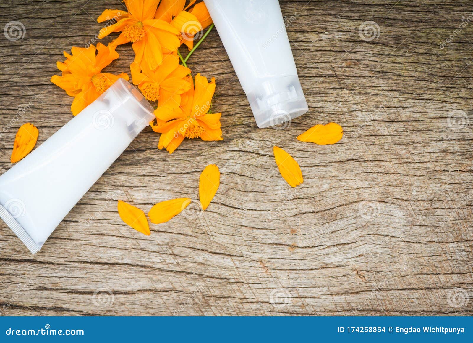 Lotion Bottle Herbal with Yellow Flower on Wood Background - Lotion