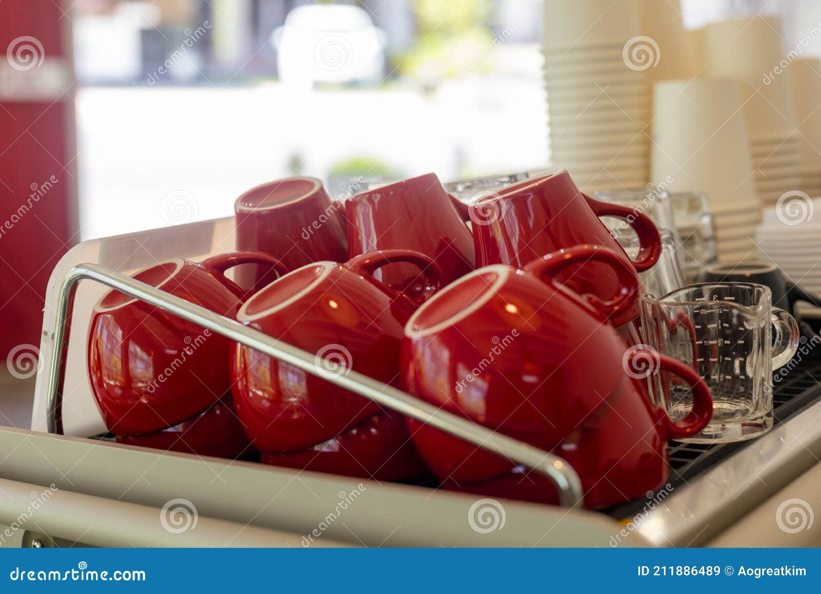 Lots of Ceramic Red Coffee Cups on Espresso Machine Shelf in Coffee