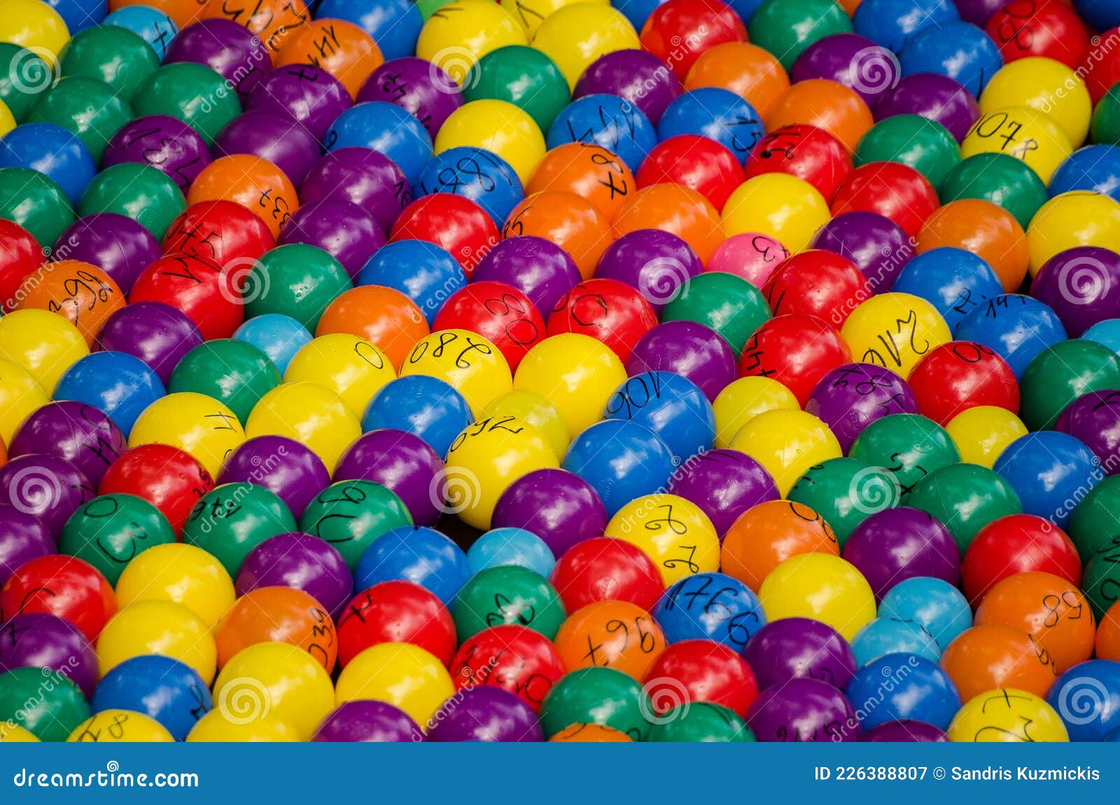 Lots of Colorful Plastic Balls with Numbers in the River Stock Image