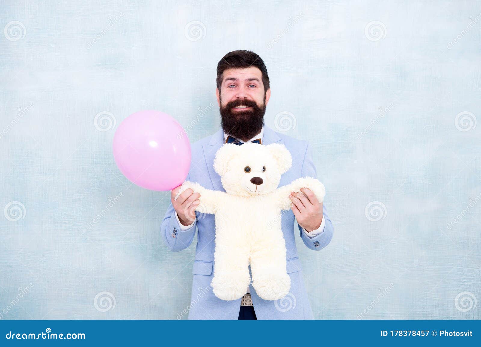 love is in the air. romantic man in tuxedo bow tie. gift with love. stereotypical presents. romantic man with teddy bear
