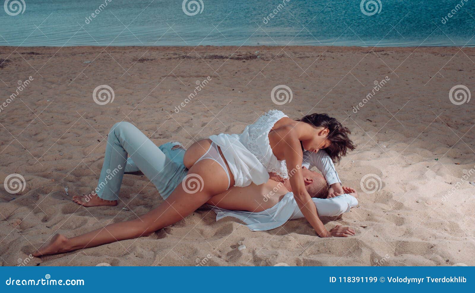Cute couple is having a rest on the beach naked