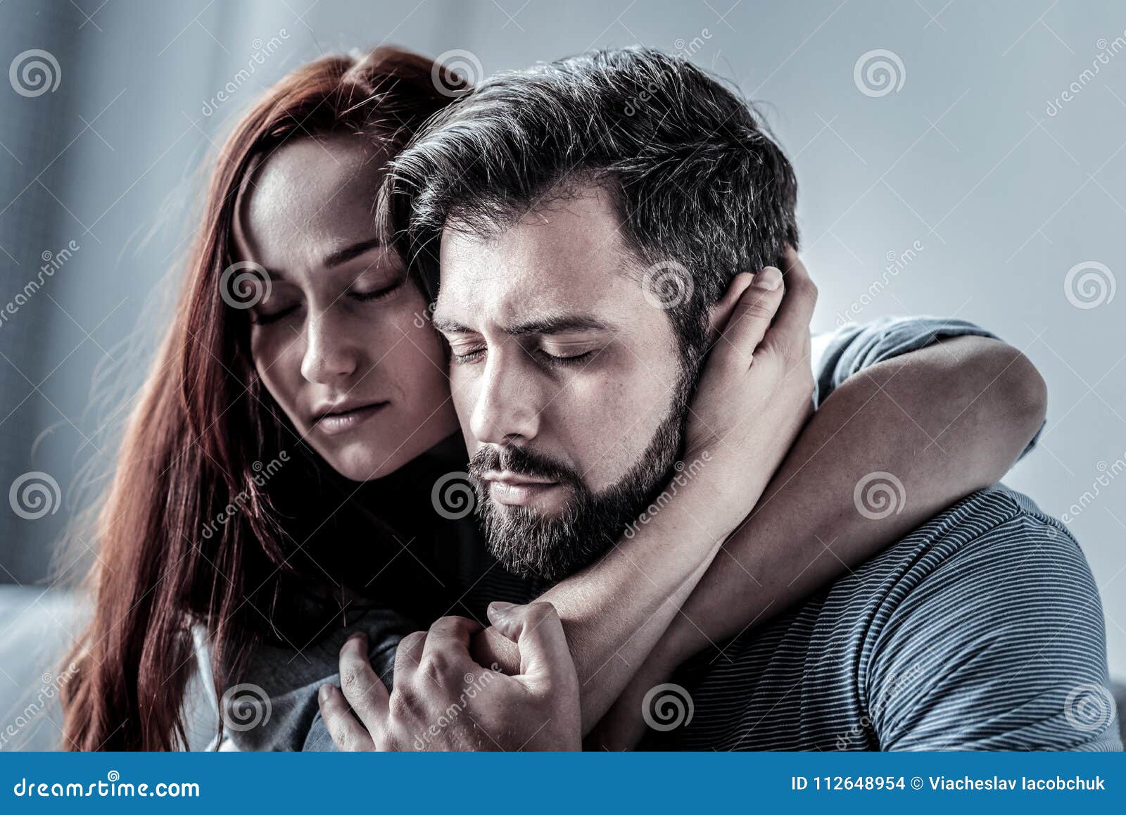 Redhead Satisfied Woman Hugging Her Husband Closing Her Eyes. Stock ...