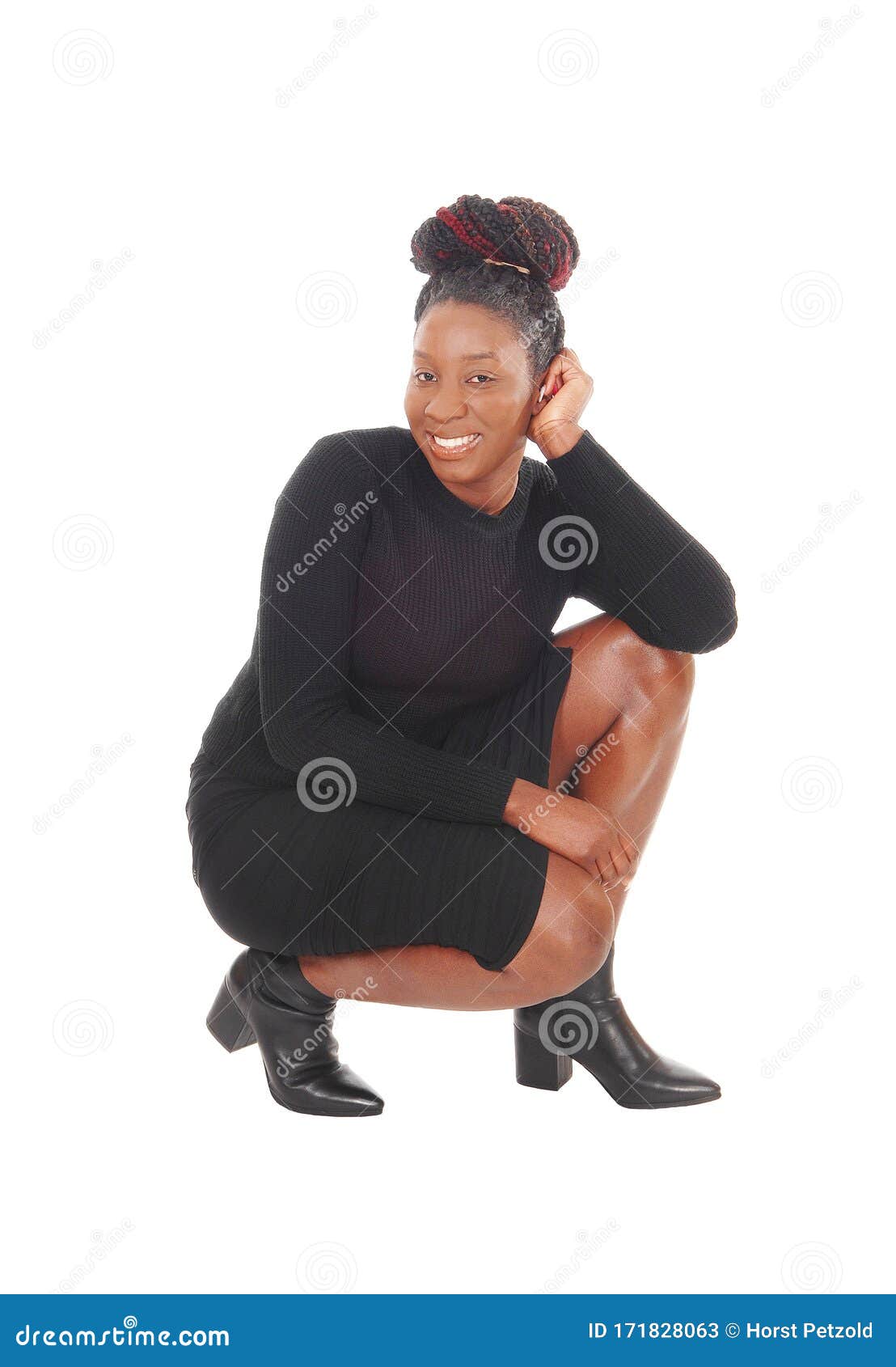 A lovely woman in a short dress and black leggings crouching on the floor  with her long red hair, isolated for white background Stock Photo - Alamy