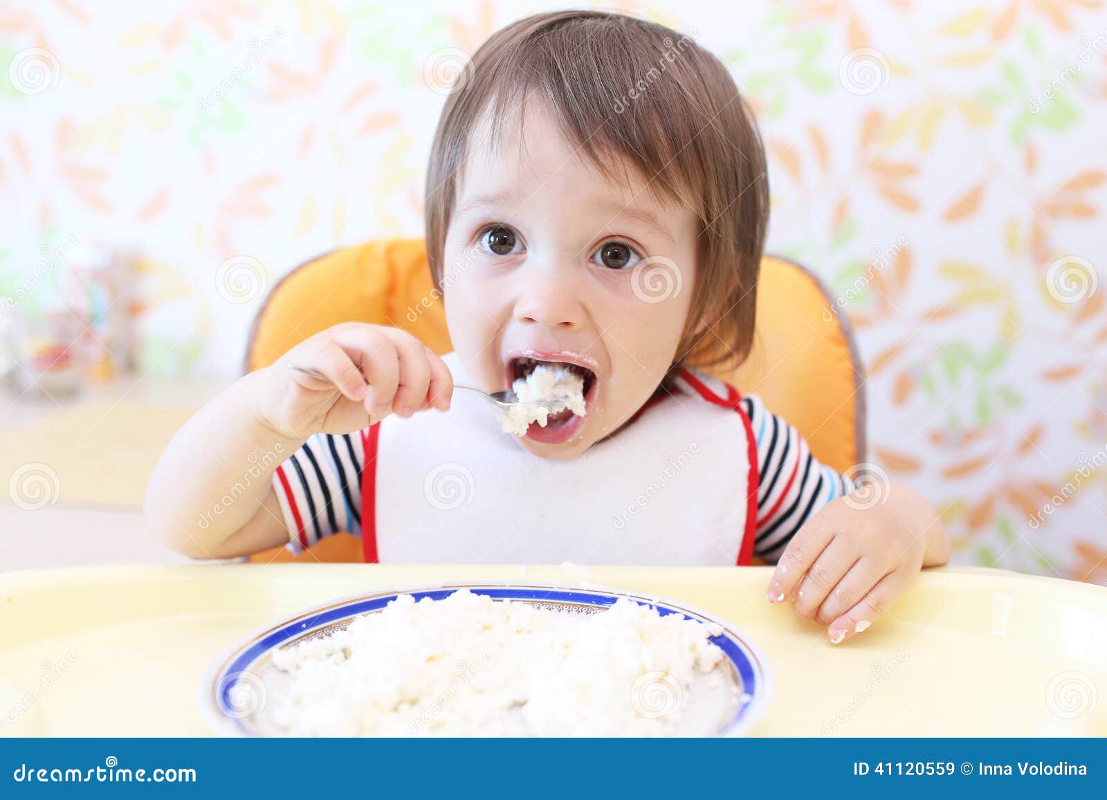 Lovely baby eating quark stock image. Image of highchair 41120559