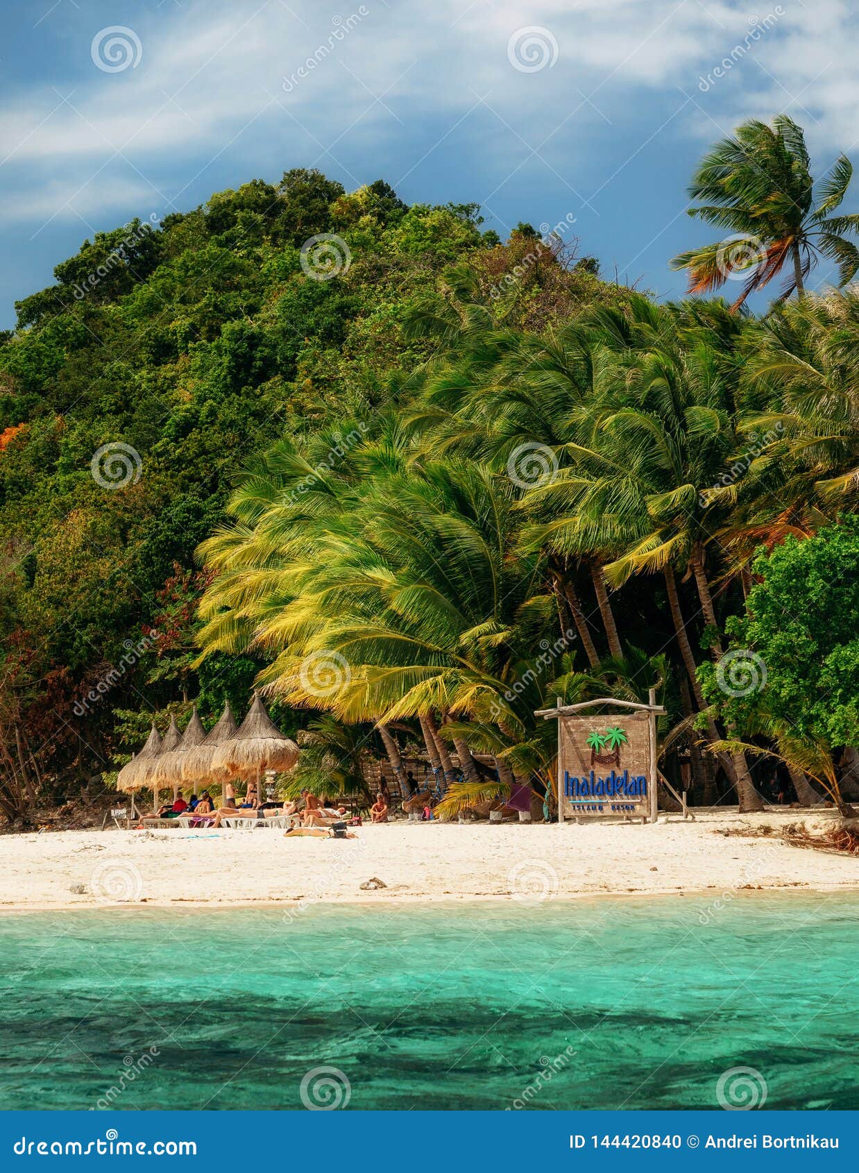 Lovely Beach With Turquoise Water And Green Palm Trees On A Tropical