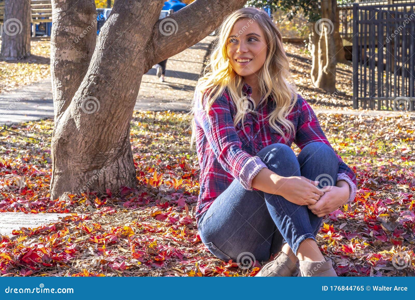 A Lovely Blonde Model Enjoys An Autumn Day Outdoors At The Park Stock