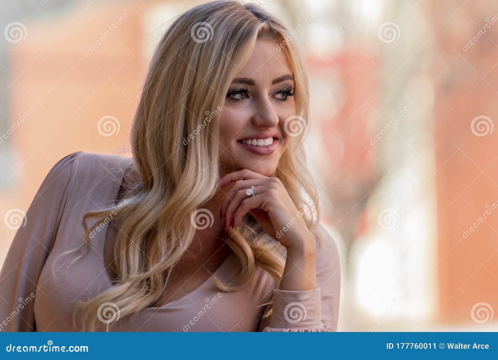 A Lovely Blonde Model Enjoys An Autumn Day Outdoors In A Small Town