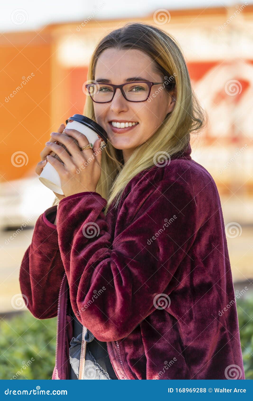 A Lovely Blonde Model Enjoys An Autumn Day Outdoors In A Small Town