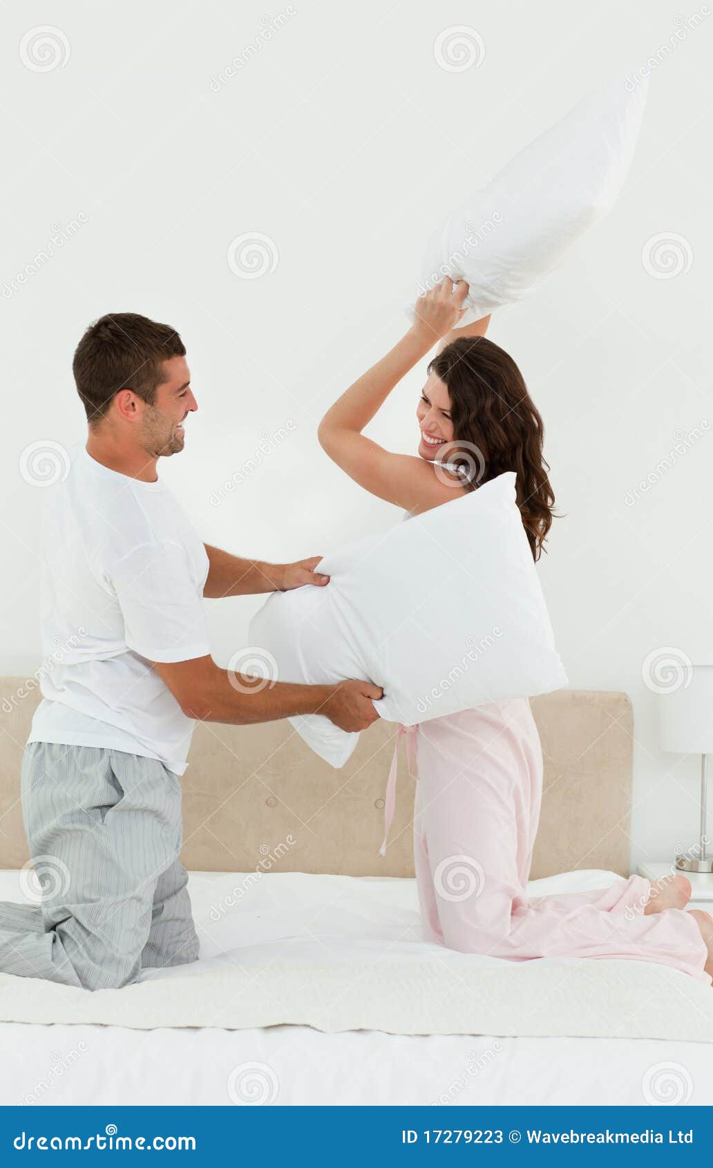 Lovely Couple Doing a Pillow Fight on Their Bed Stock Image Image of