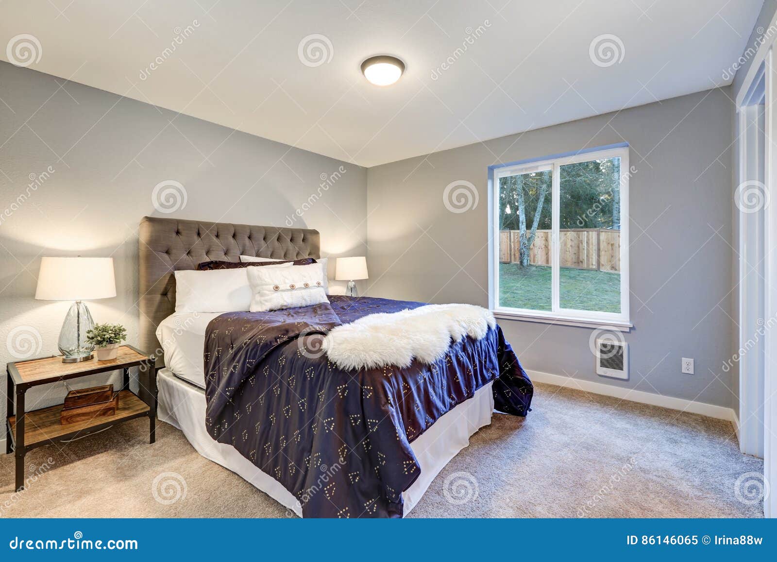 Lovely Master Bedroom With Soft Grey Walls Stock Image