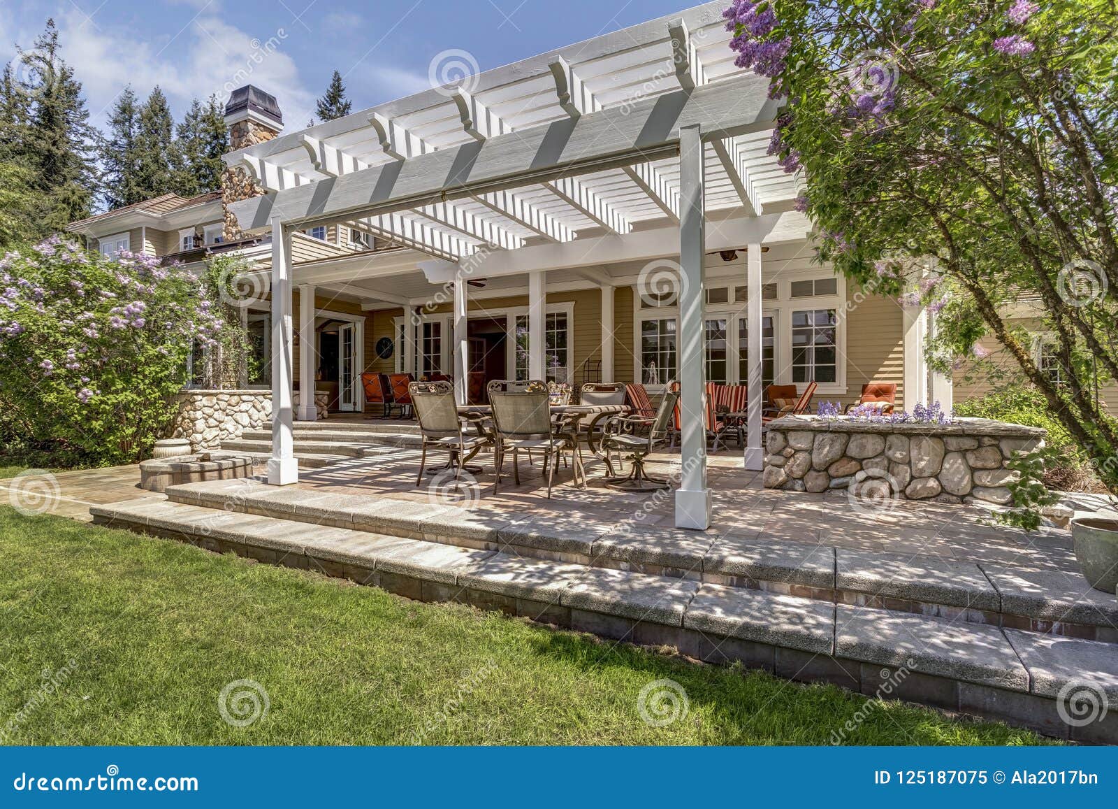 lovely outdoor deck patio space with white dining pergola.