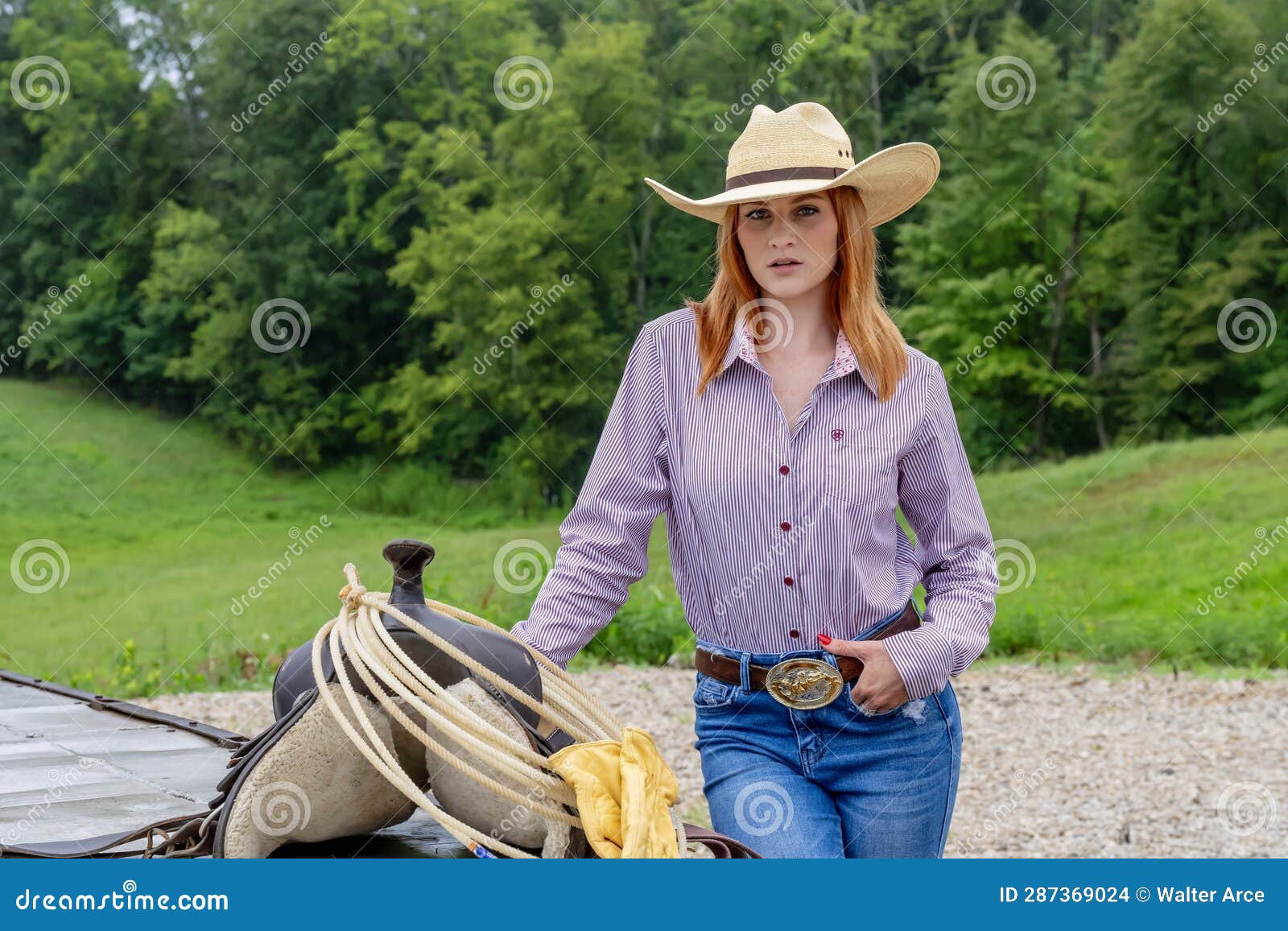 A Lovely Red Headed Country Wetern Model Poses Outdoors in a Country ...