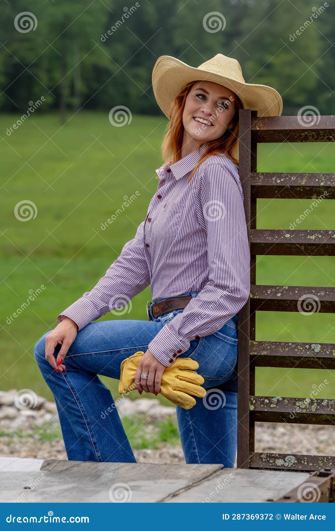 A Lovely Red Headed Country Wetern Model Poses Outdoors in a Country ...