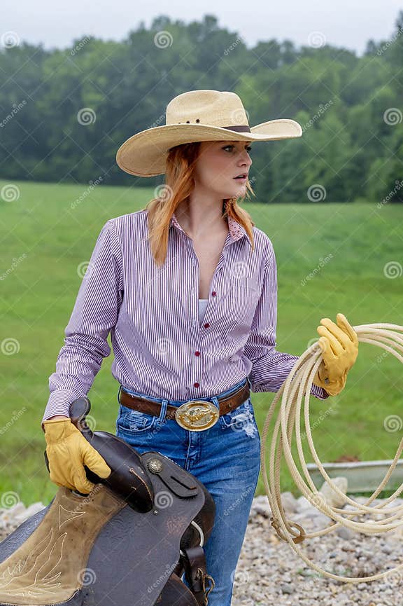 A Lovely Red Headed Country Wetern Model Poses Outdoors in a Country ...