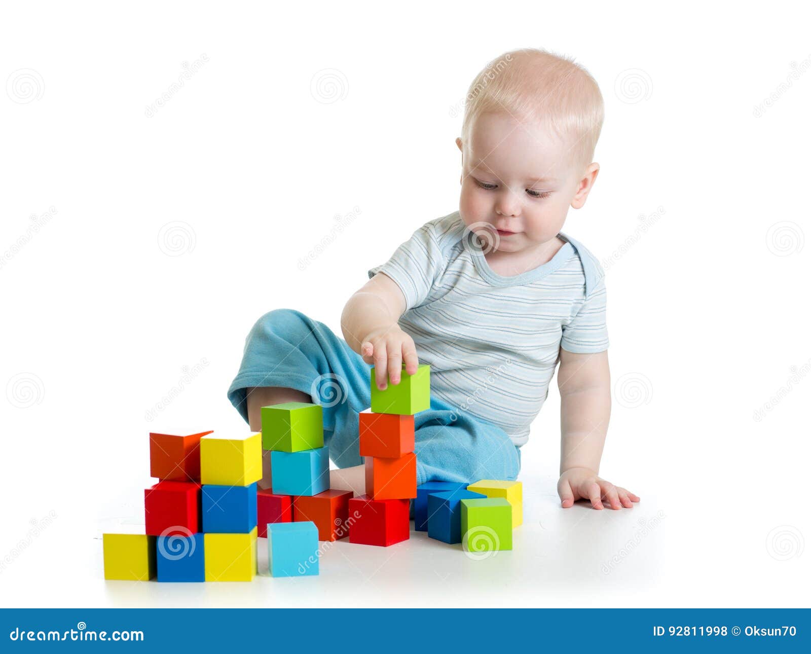lovely toddler baby playing with building cubes.  on white.