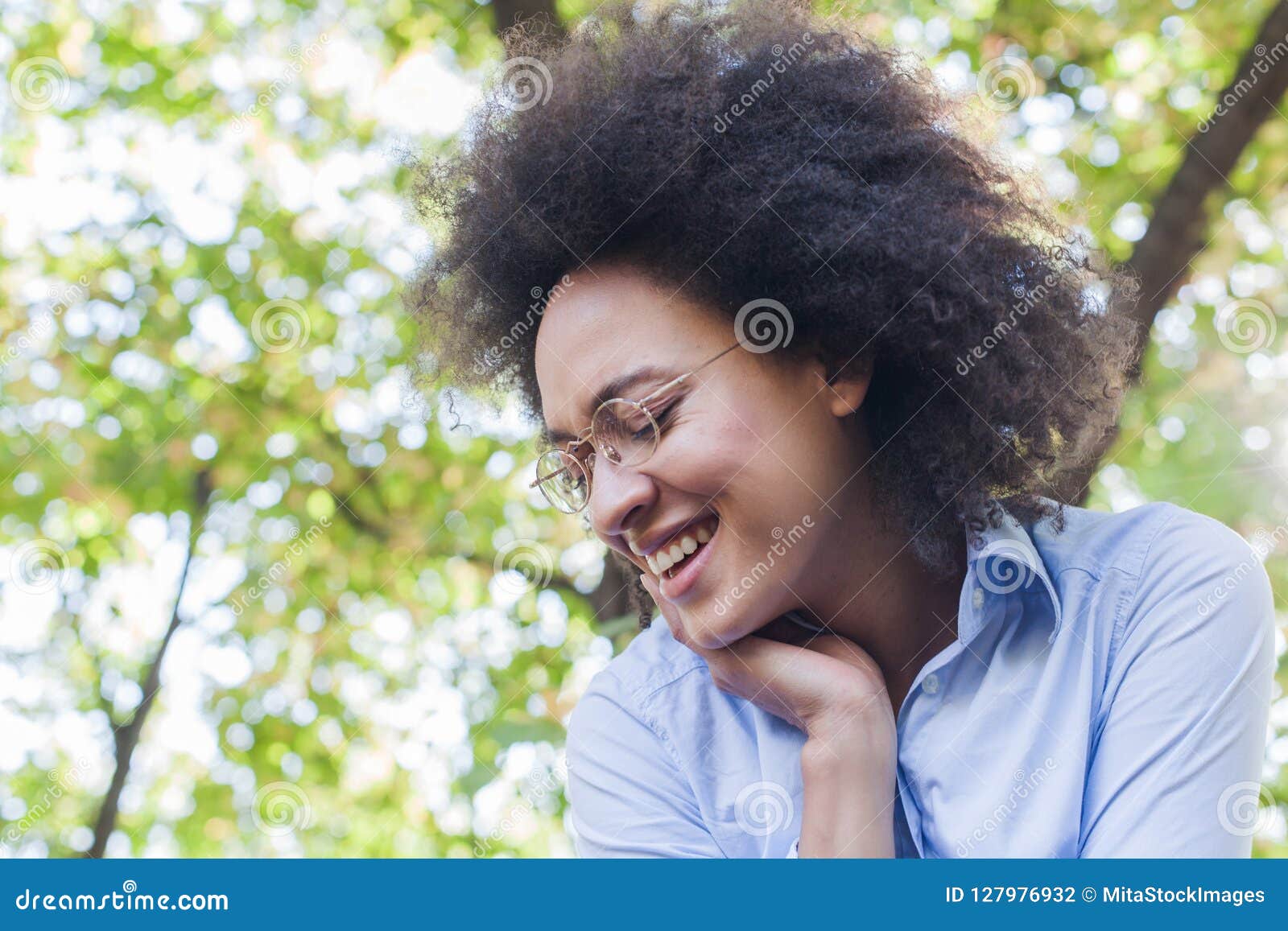 Lovely Young African American Woman Smiling In Nature Stock Photo