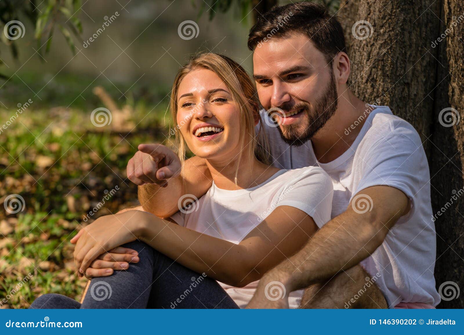 The Lover Sit Together in Public Park Pointing Finger To Something ...