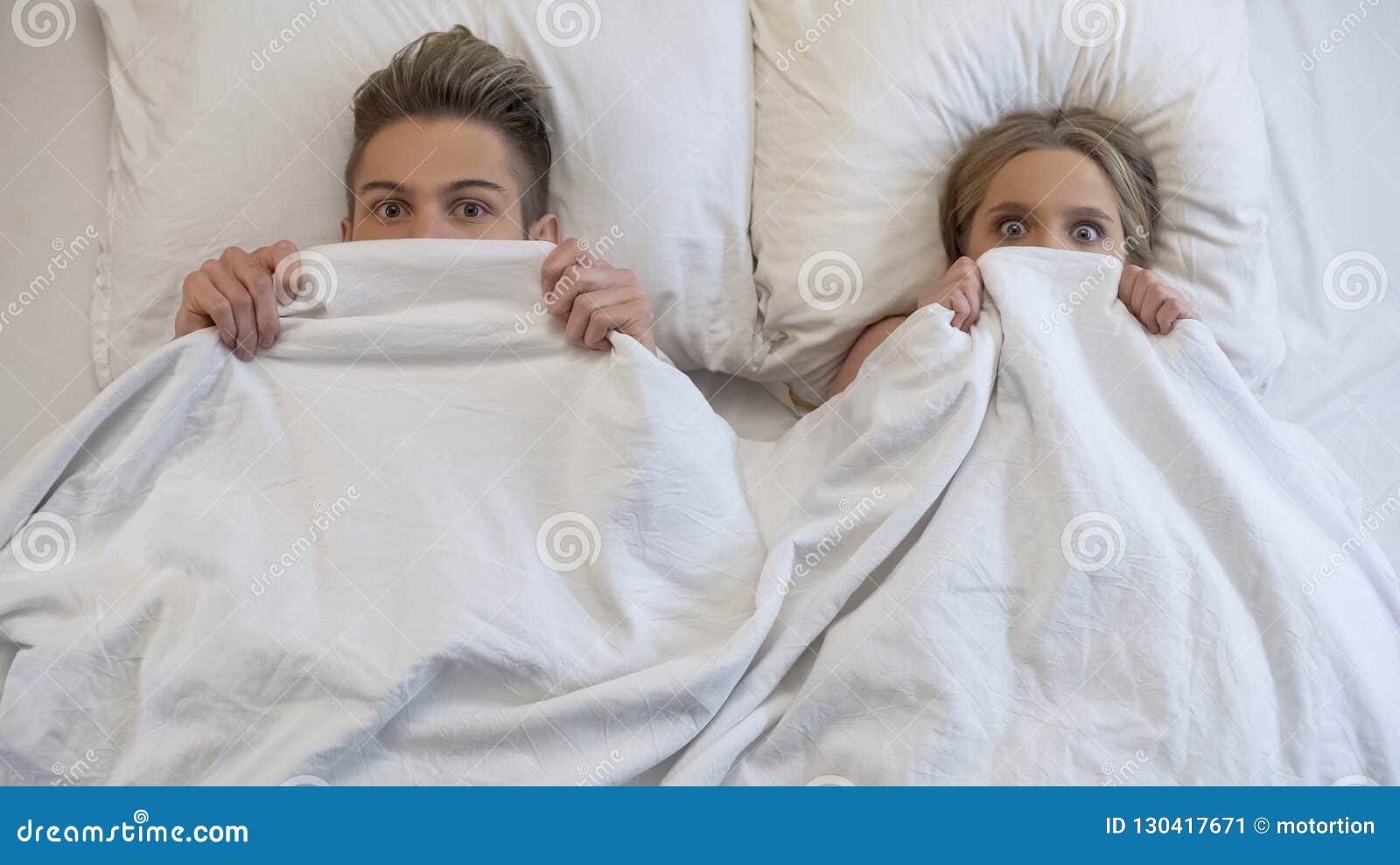 lovers caught in bed by parents, embarrassed and frightened, looking shocked