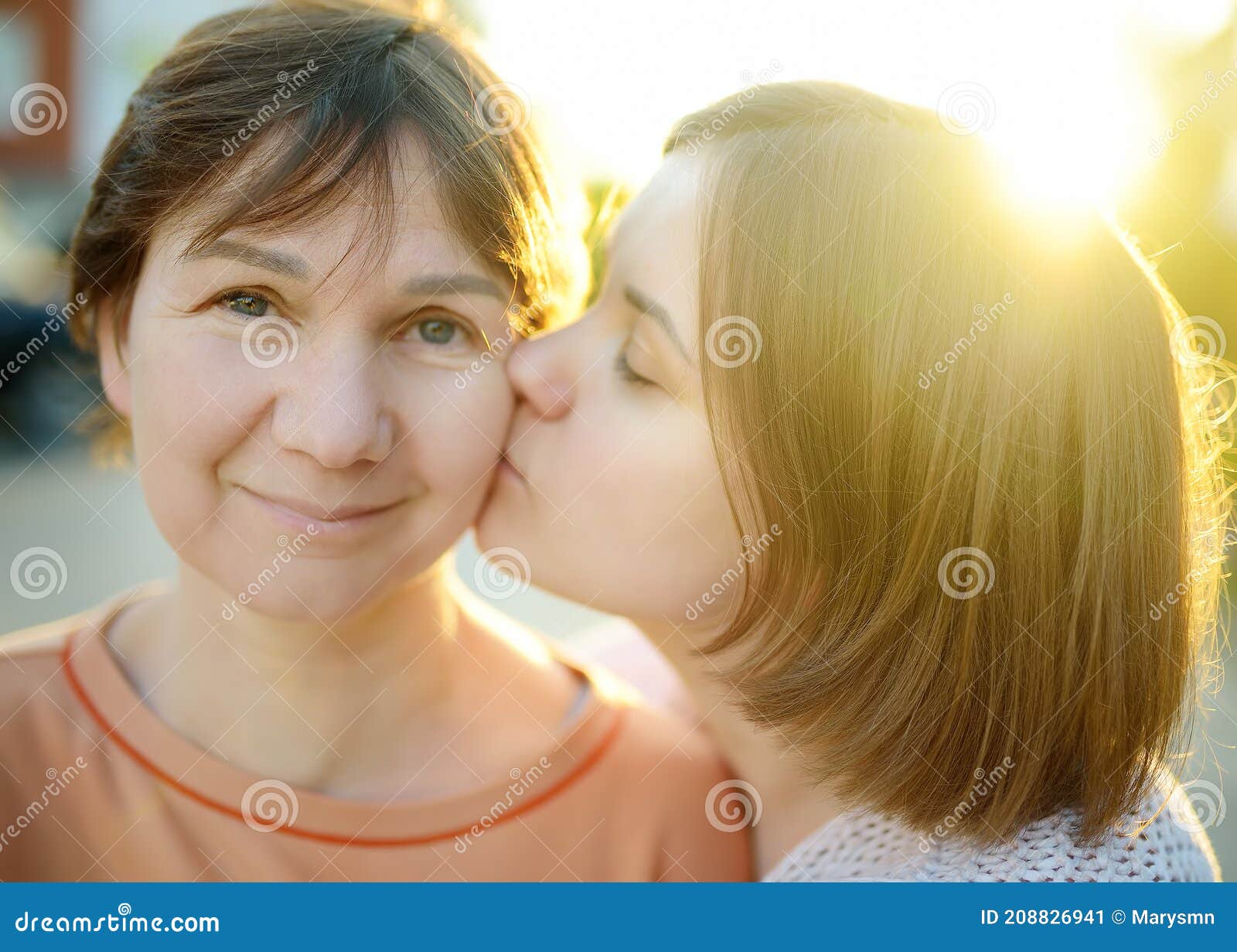 Loving Adult Daughter Hugs And Kisses Her Mature Mom A Tender 