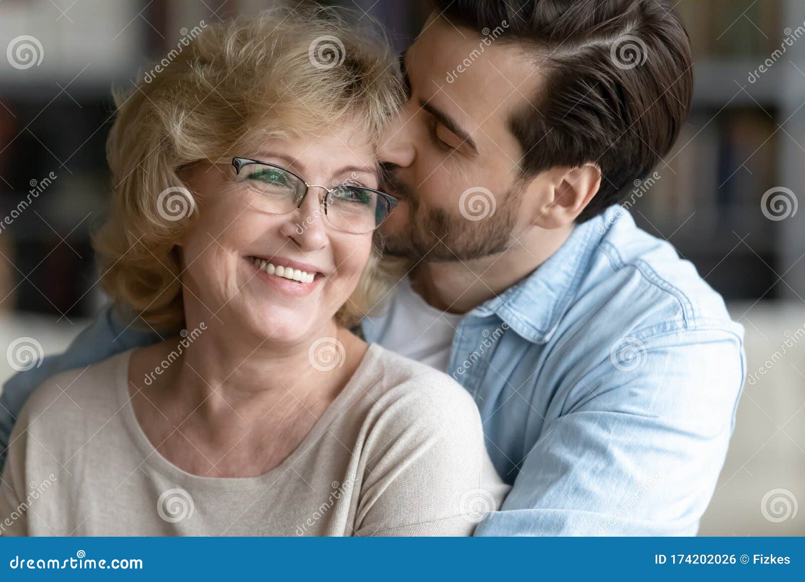 Loving Grown Up Daughter Congratulating Mature Mother Presenting Gift