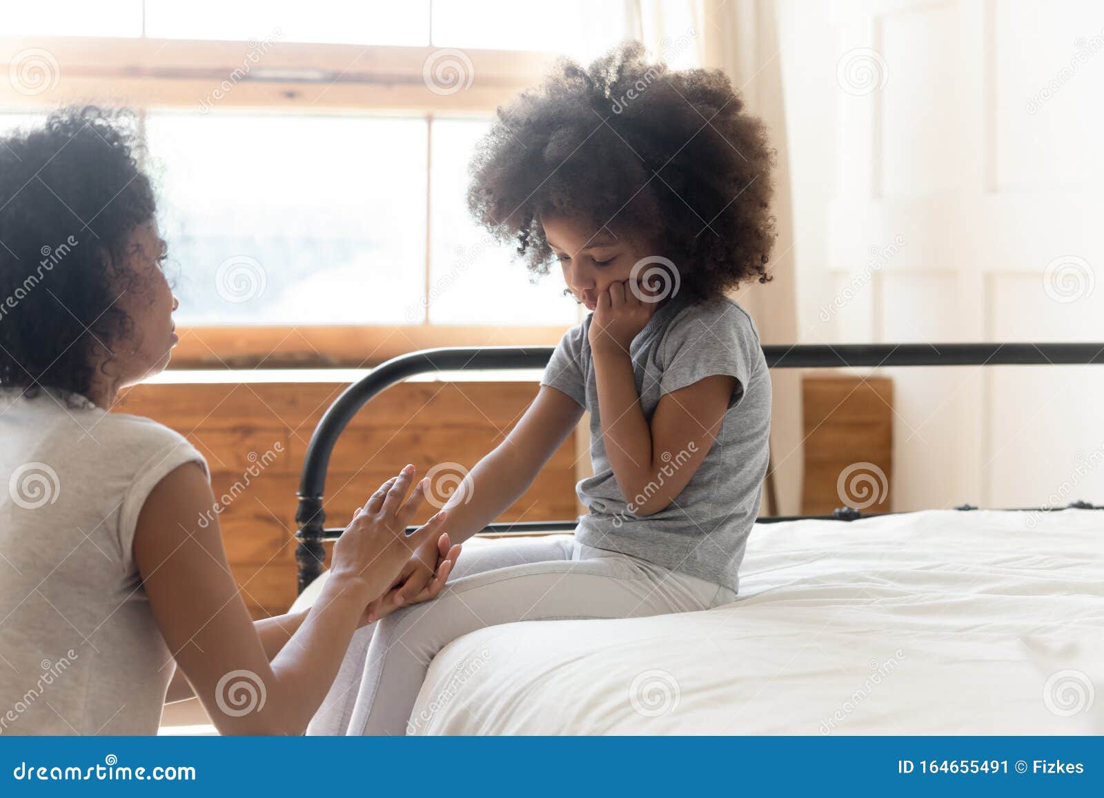 loving biracial mom caress comfort sad little daughter