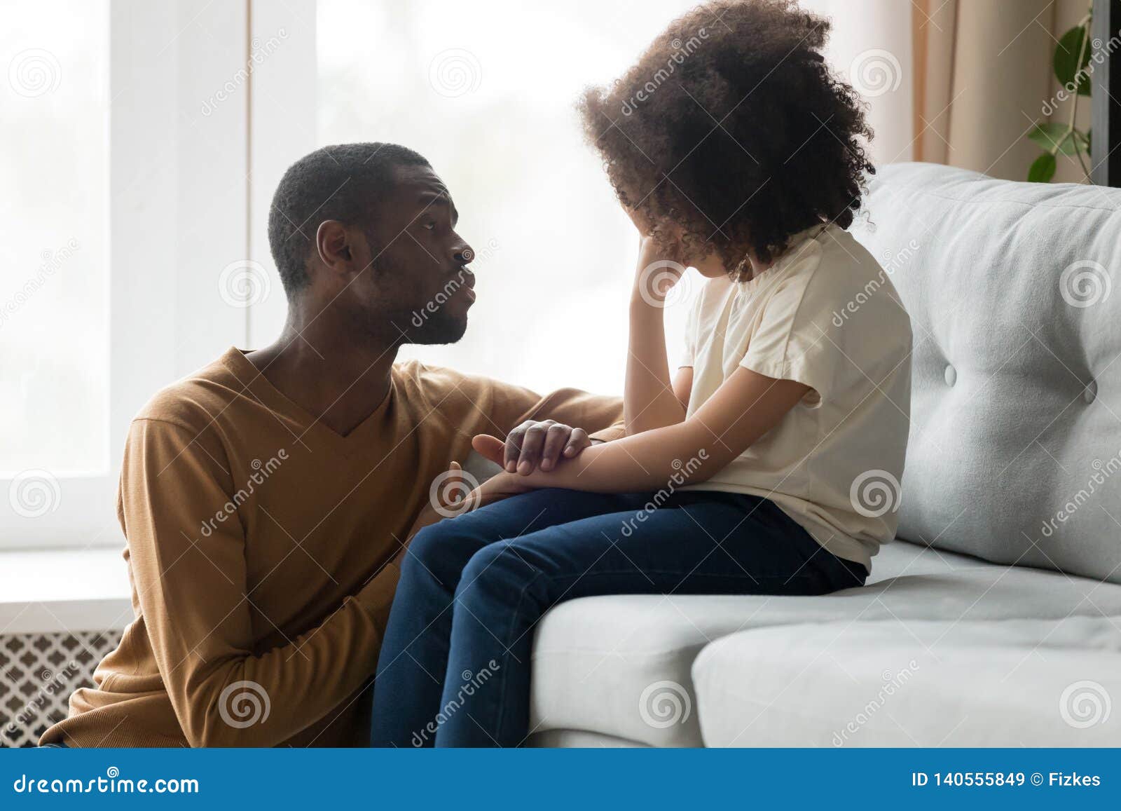 loving african dad comforting crying kid daughter showing empathy
