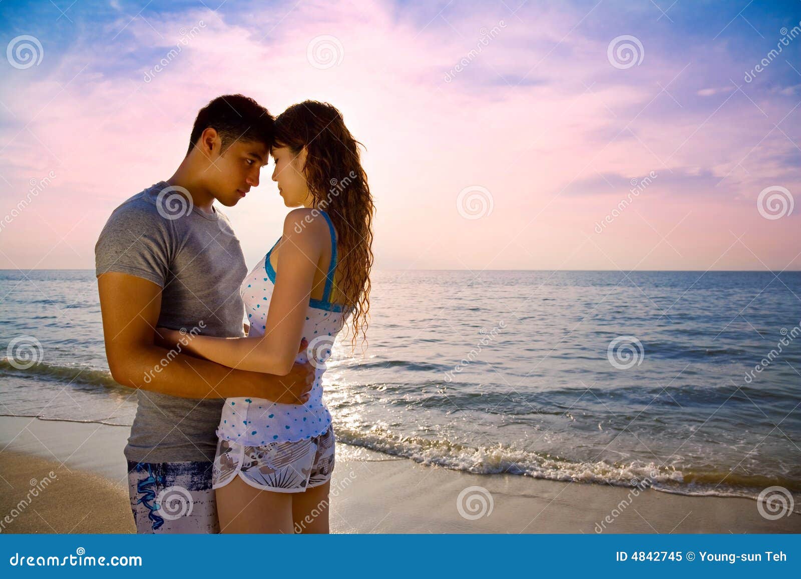 Loving Couple On A Beautiful Sunset Beach Royalty Free