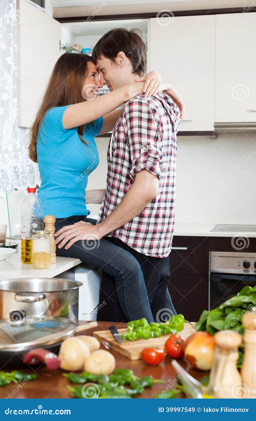 Loving Couple Having Sex at Table in Kitchen Stock Image