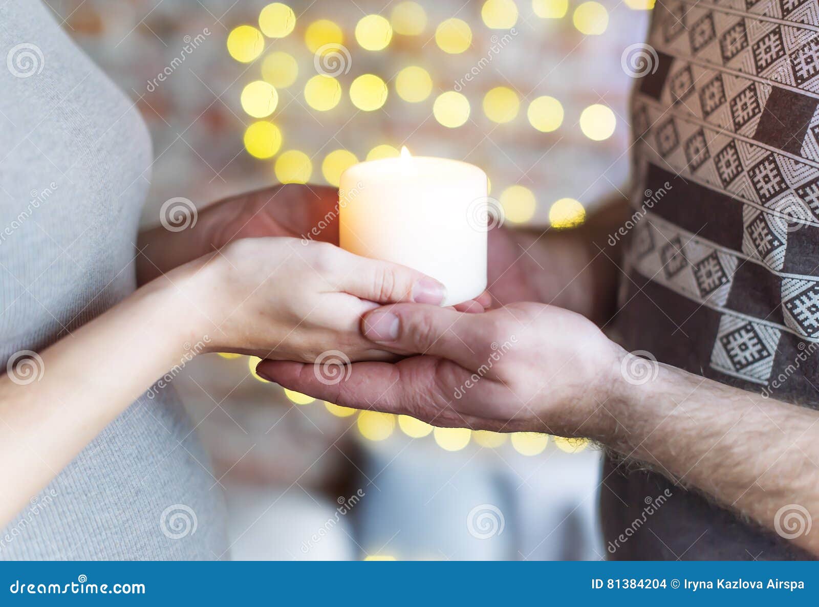 The Loving Couple Holds the Burning Candle in Hand. the Woman is