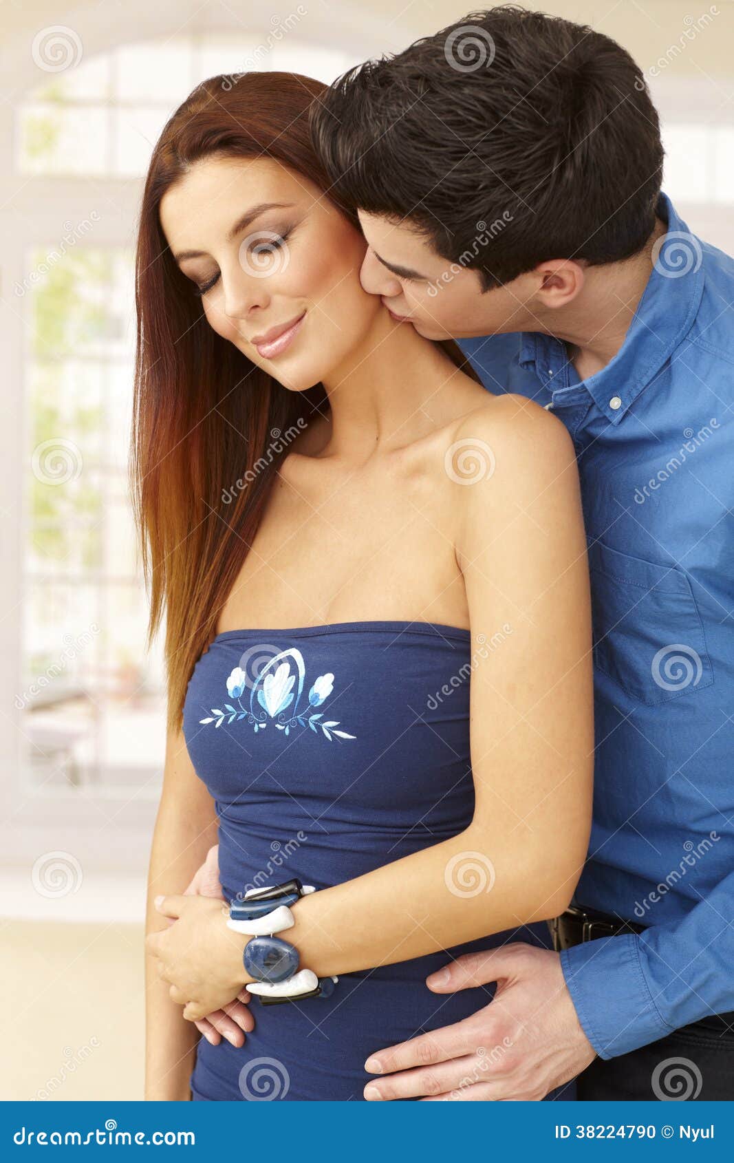 Young loving couple kissing and embracing.