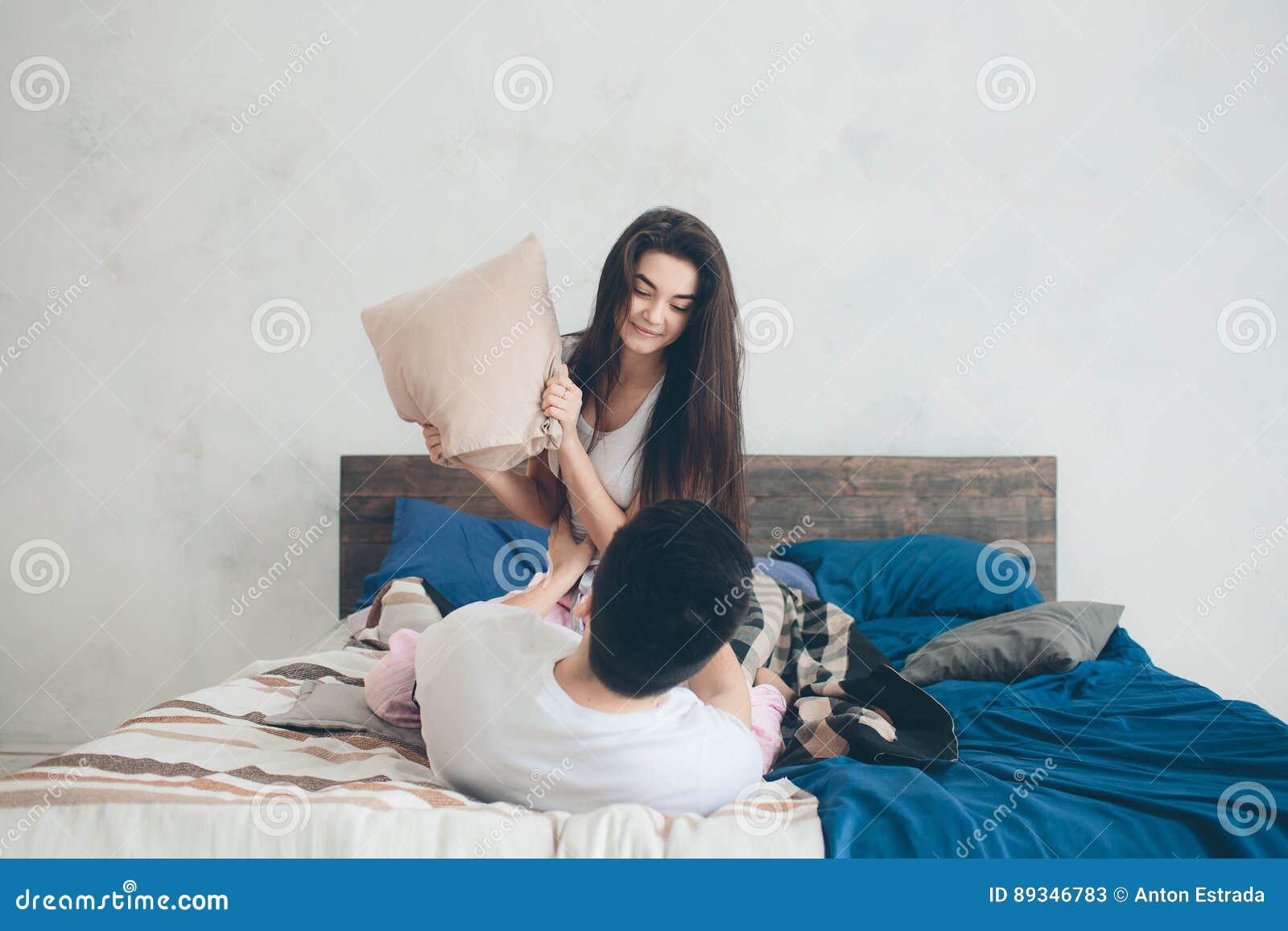 A Loving Couple Are Lying On The Bed Bright And Cozy